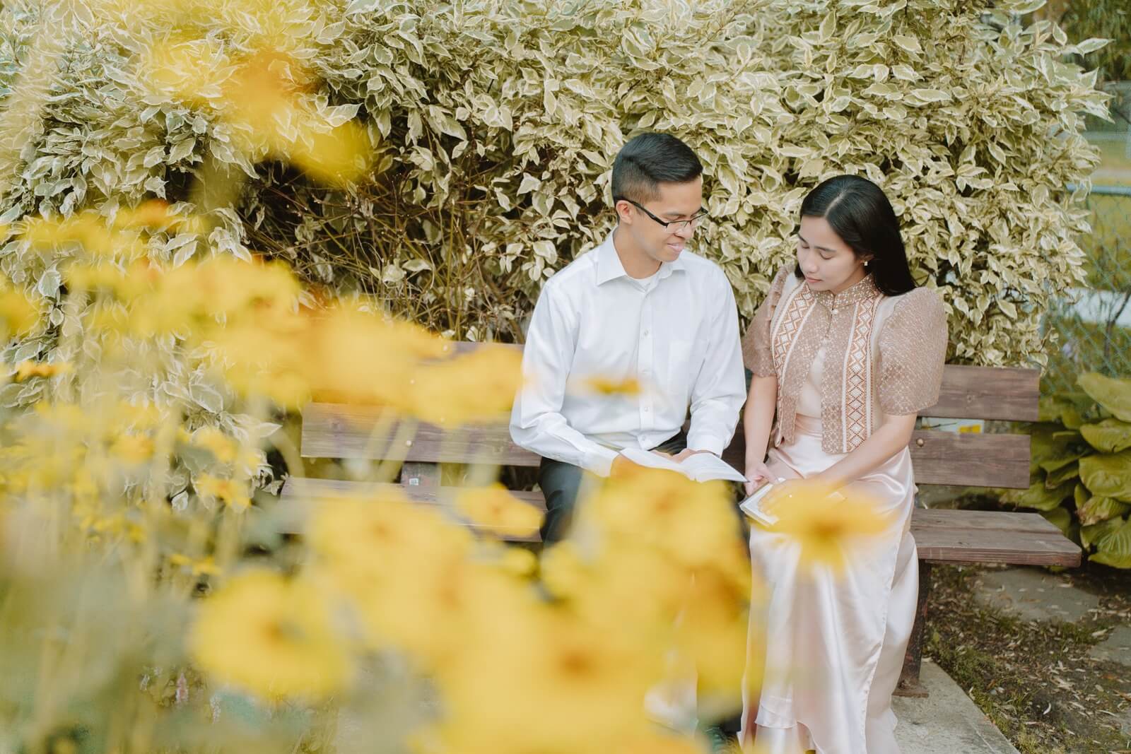 Kevin and Ruth sitting together among flowers
