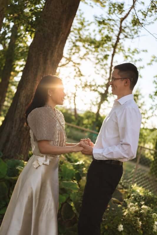Kevin and Ruth holding hands beneath a tree
